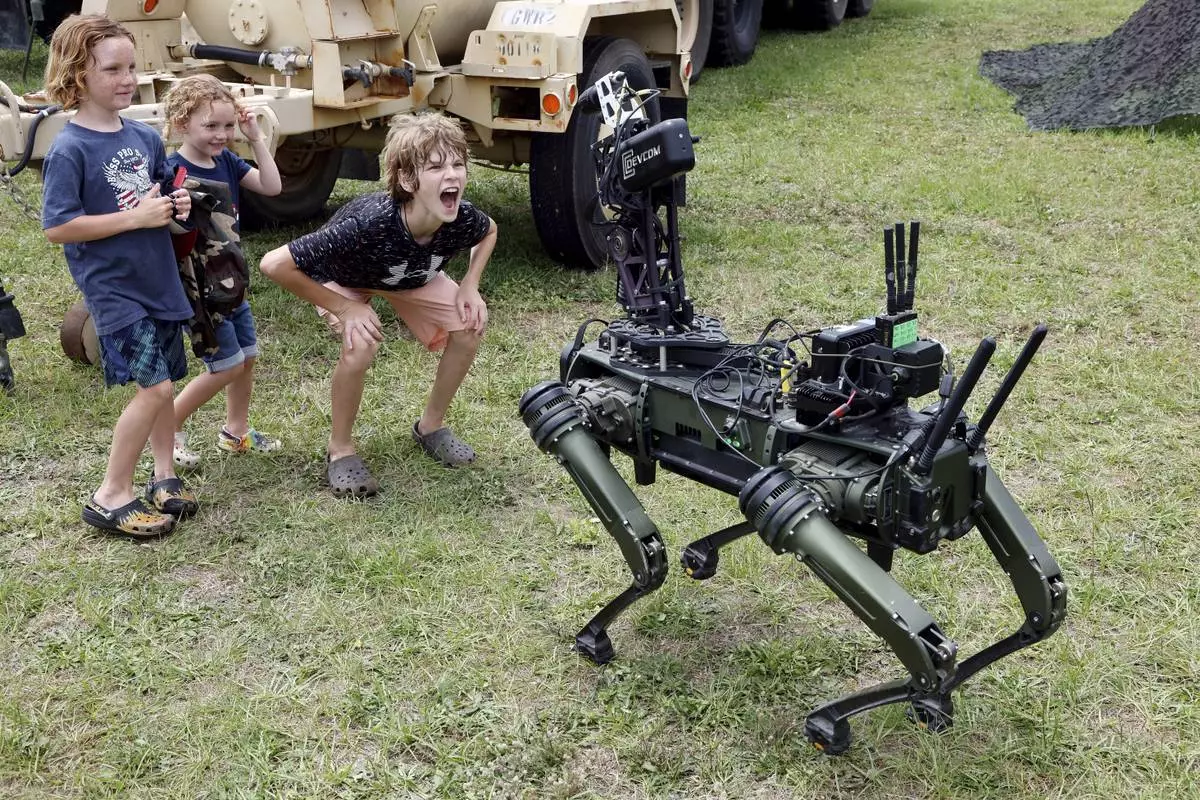 "Lone Wolf" a military robotic dog interacts with visitors at the America 250 Celebration at Fort Bragg in Fayetteville, N.C., Tuesday, June 10, 2025. (AP Photo/Karl DeBlaker)