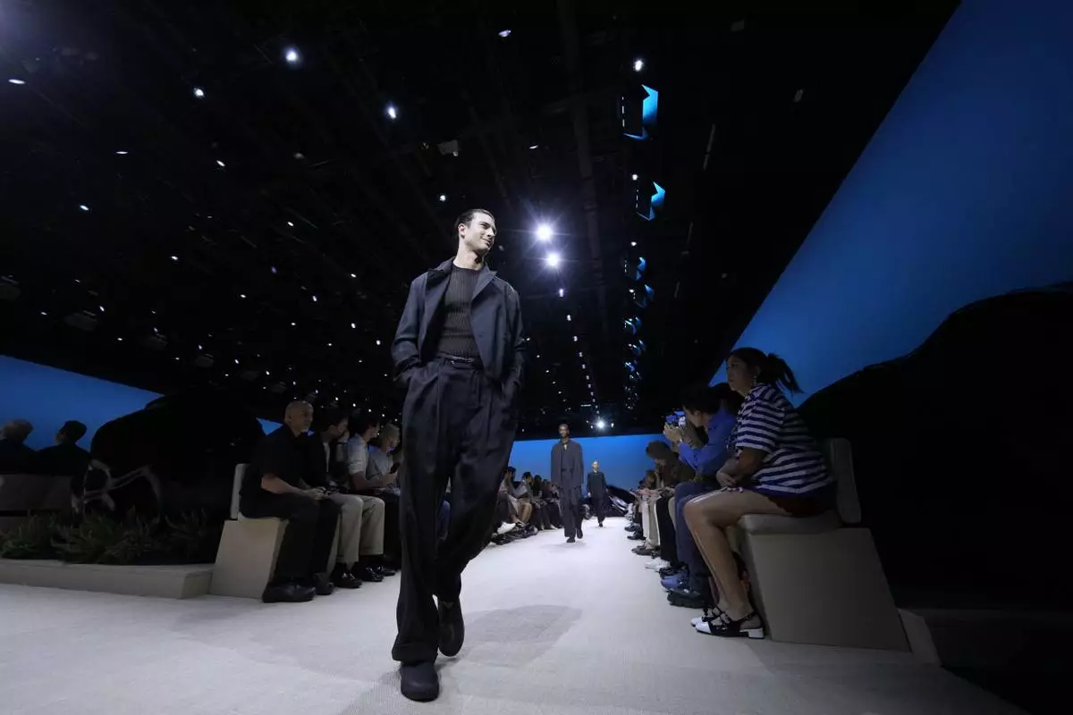 A model wears a creation as part of the men's Giorgio Armani Spring-Summer 2026 collection, that was presented in Milan, Italy, Monday, June 23, 2025. (AP Photo/Luca Bruno)