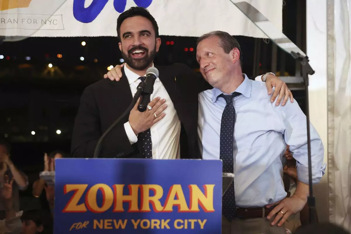 Democratic mayoral candidate Zohran Mamdani, left, speaks on stage with fellow candidate Comptroller Brad Lander at his primary election party, Wednesday, June 25, 2025, in New York. (AP Photo/Heather Khalifa)