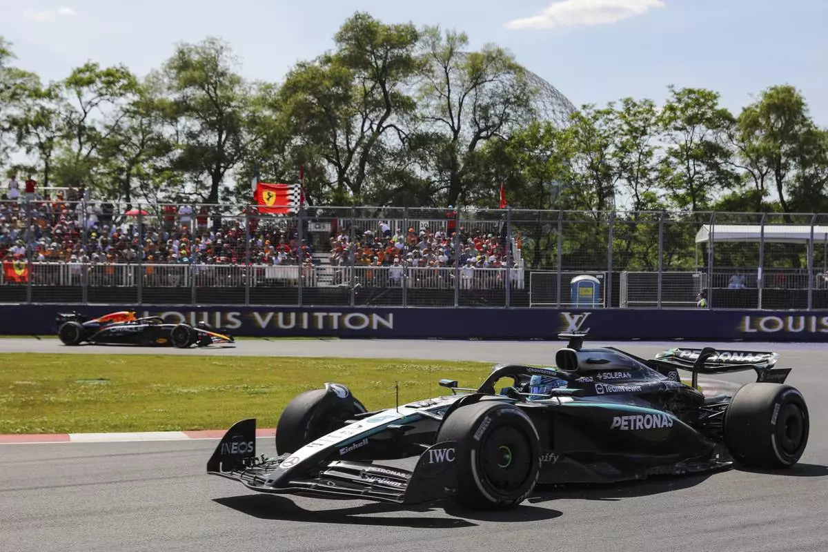 Mercedes driver, Britain's George Russell leads Red Bull Racing driver Max Verstappen, of the Netherlands, through the hairpin during Formula One auto racing action at the Canadian Grand Prix, in Montreal on Sunday, June 15, 2025. (Evan Buhler/The Canadian Press via AP)