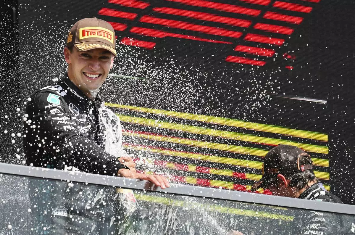 Mercedes driver, Britain's George Russell is sprayed by teammate Kimi Antonelli, right, of Italy, after winning the F1 Canadian Grand Prix auto race in Montreal, Sunday, June 15, 2025. (Graham Hughes/The Canadian Press via AP)