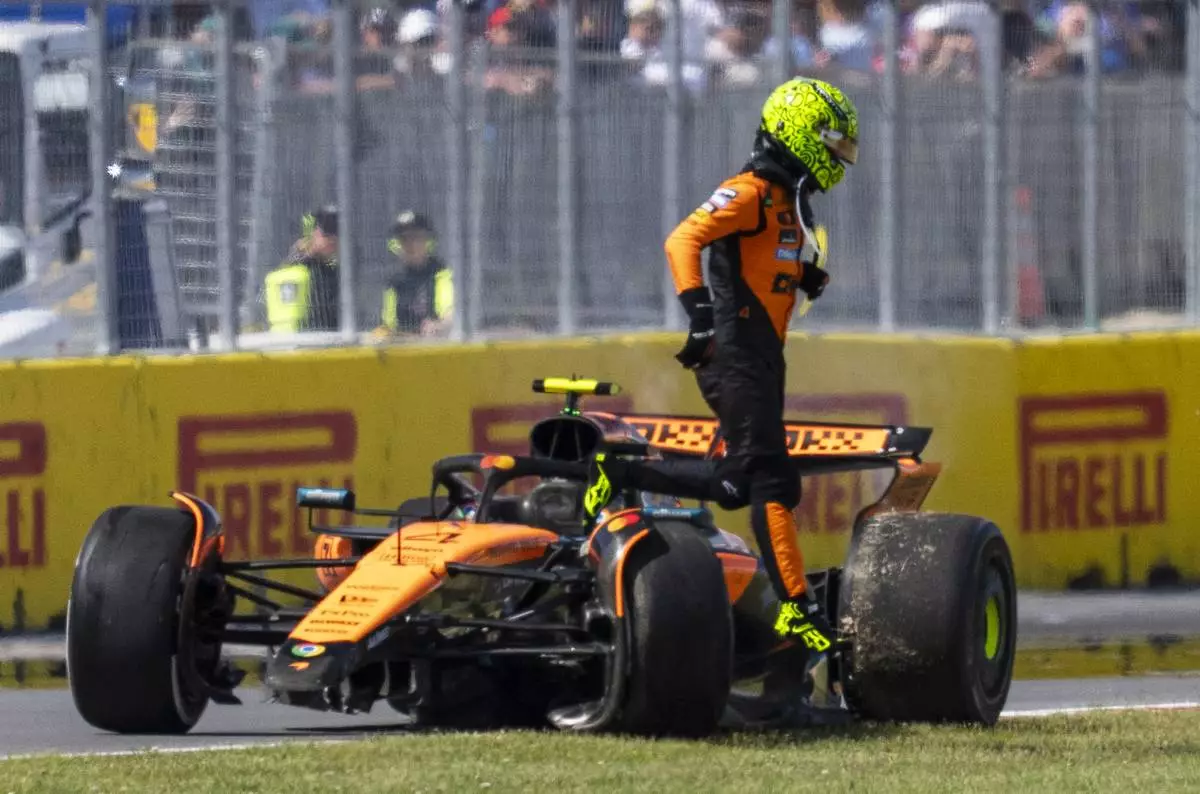 McLaren driver, Britain's Lando Norris walks away from his car following a collision during the F1 Canadian Grand Prix auto race in Montreal, Sunday, June 15, 2025. (Christopher Katsarov/The Canadian Press via AP)