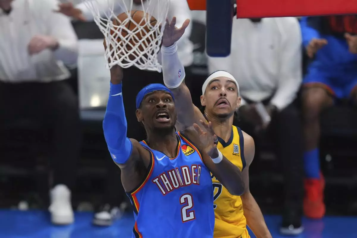 Oklahoma City Thunder guard Shai Gilgeous-Alexander, left, shoots against Indiana Pacers guard Andrew Nembhard during the second half of Game 7 of the NBA Finals basketball series Sunday, June 22, 2025, in Oklahoma City. (AP Photo/Nate Billings)