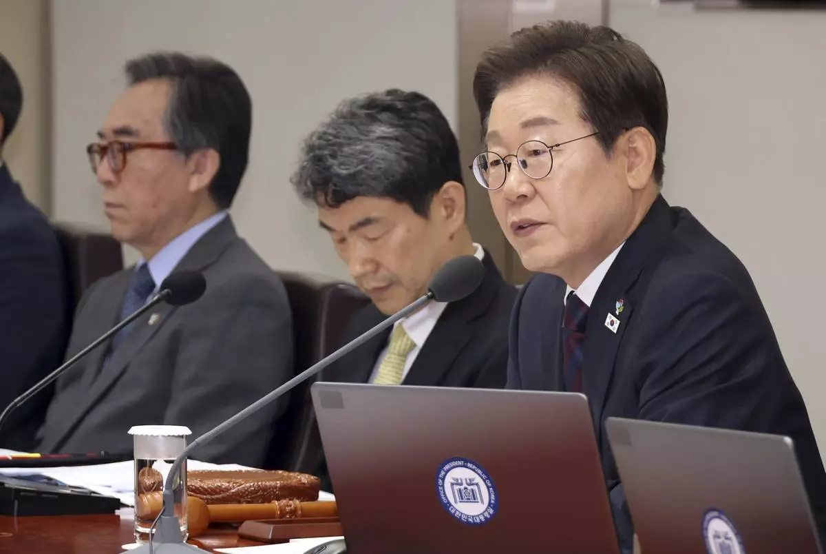 South Korean President Lee Jae-myung, right, speaks during a cabinet meeting at the presidential office in Seoul, South Korea, Tuesday, June 10, 2025. (Han Sang-kyu/Yonhap via AP)