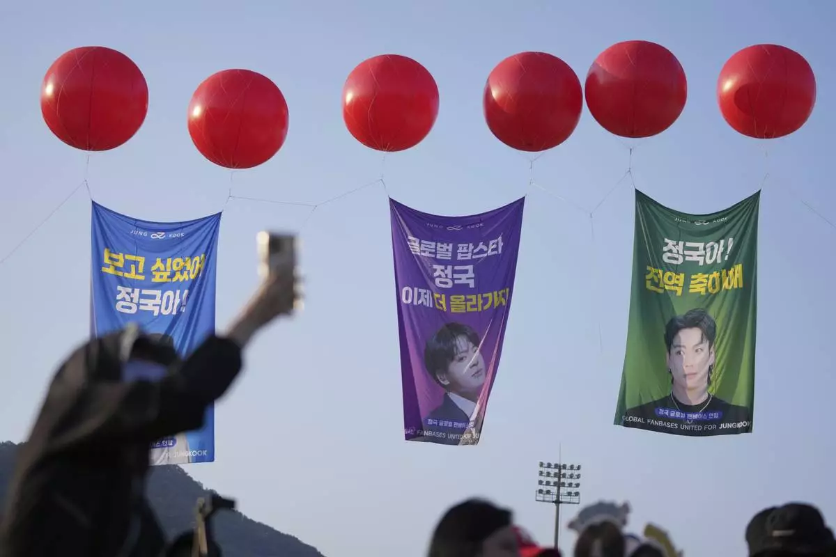 Fans wait for arrival of K-pop band BTS members Jimin and Jung Kook in Yeoncheon, South Korea, Wednesday, June 11, 2025. (AP Photo/Lee Jin-man)