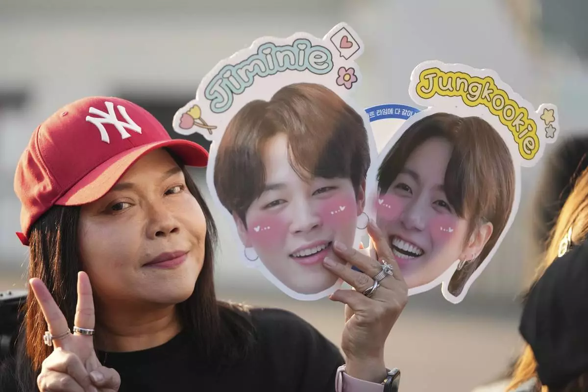 A fan from Thailand waits for arrival of K-pop band BTS members Jimin and Jung Kook in Yeoncheon, South Korea, Wednesday, June 11, 2025. (AP Photo/Lee Jin-man)