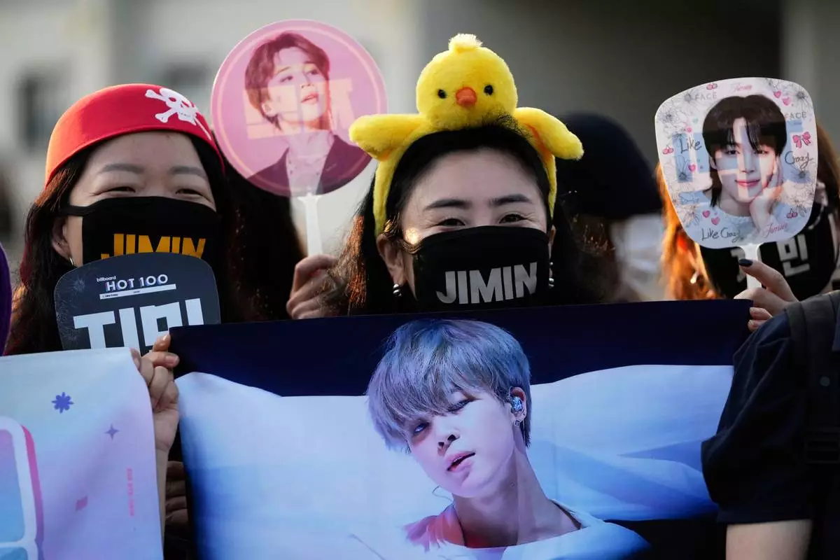 Fans wait for arrival of K-pop band BTS members Jimin and Jung Kook in Yeoncheon, South Korea, Wednesday, June 11, 2025. (AP Photo/Lee Jin-man)
