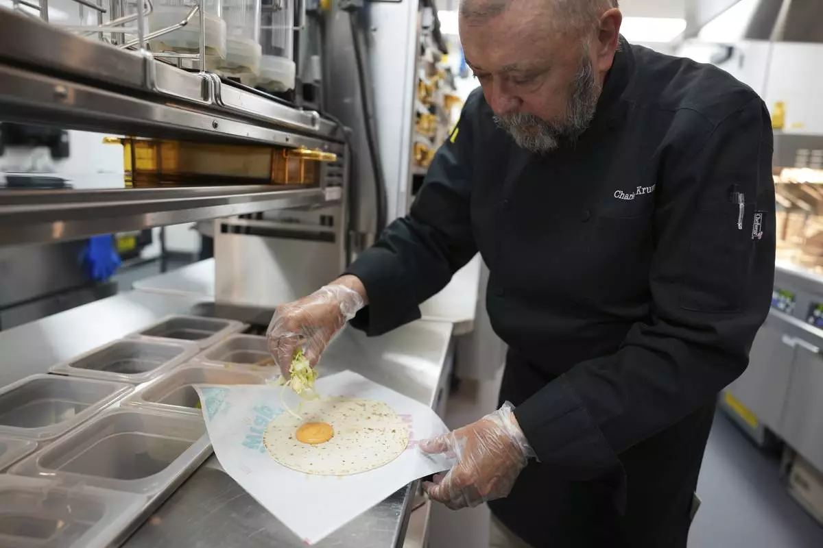 Charles L. Krumsiek, a McDonald's chef, makes a snack wrap (ranch) at McDonald's Headquarter in Chicago, Thursday, May 29, 2025. (AP Photo/Nam Y. Huh)
