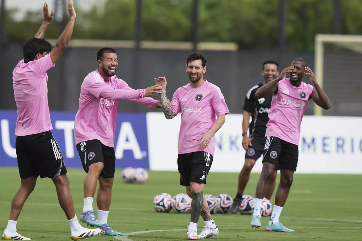 Inter Miami forward Lionel Messi, third from left, jokes with his teammates during a training session Friday, June 13, 2025, in Fort Lauderdale, Fla. in preparation for a Club World Cup soccer match Saturday. (AP Photo/Lynne Sladky)