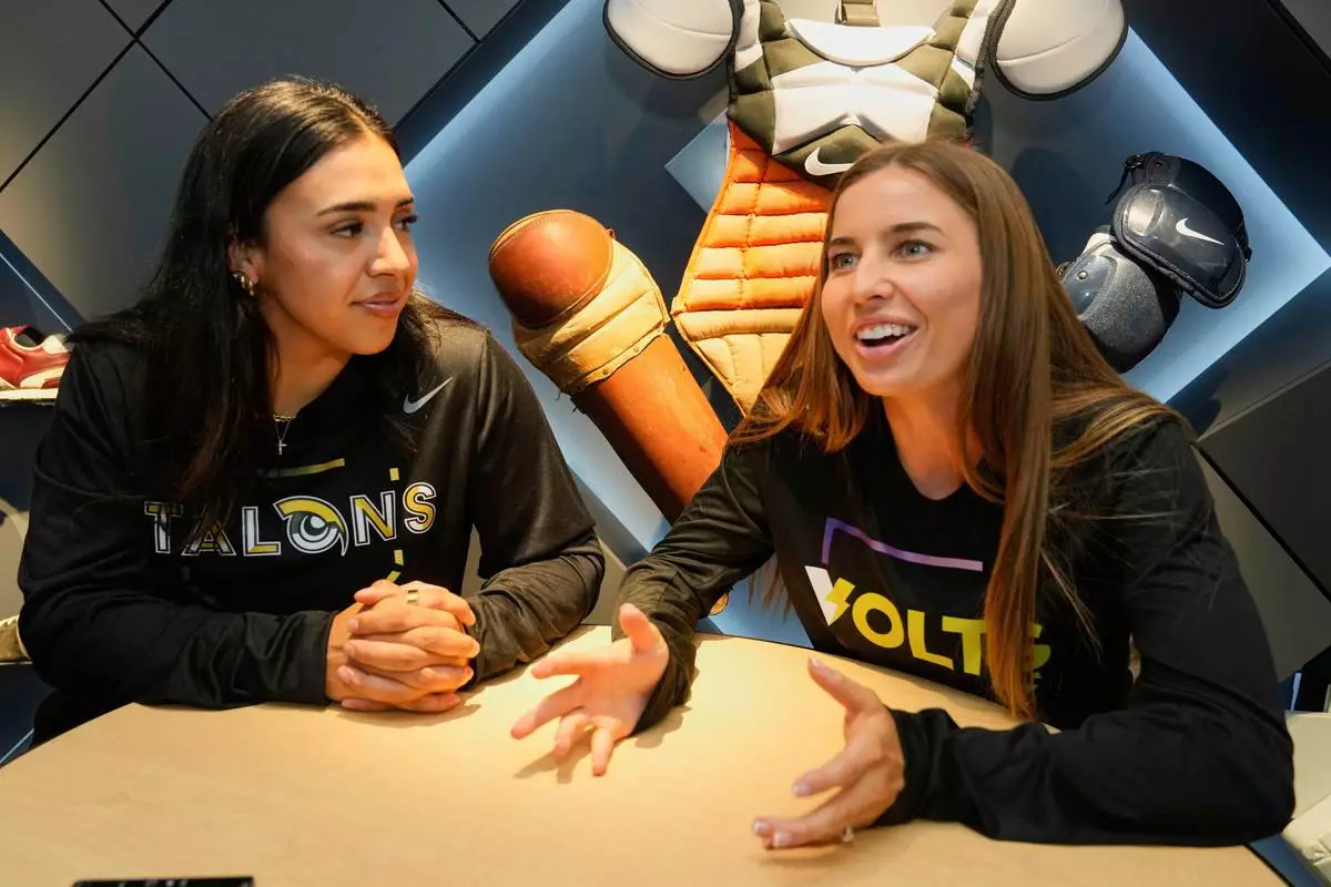 CORRECTS FIRST NAME TO SHARLIZE, NOT CHARLIE - Athletes Unlimited Softball League players Sharlize Palacios, left, of the Talons, and Sis Bates of the Bolts, are interviewed at Major League Baseball's headquarters in New York, Thursday, May 29, 2025. (AP Photo/Richard Drew)