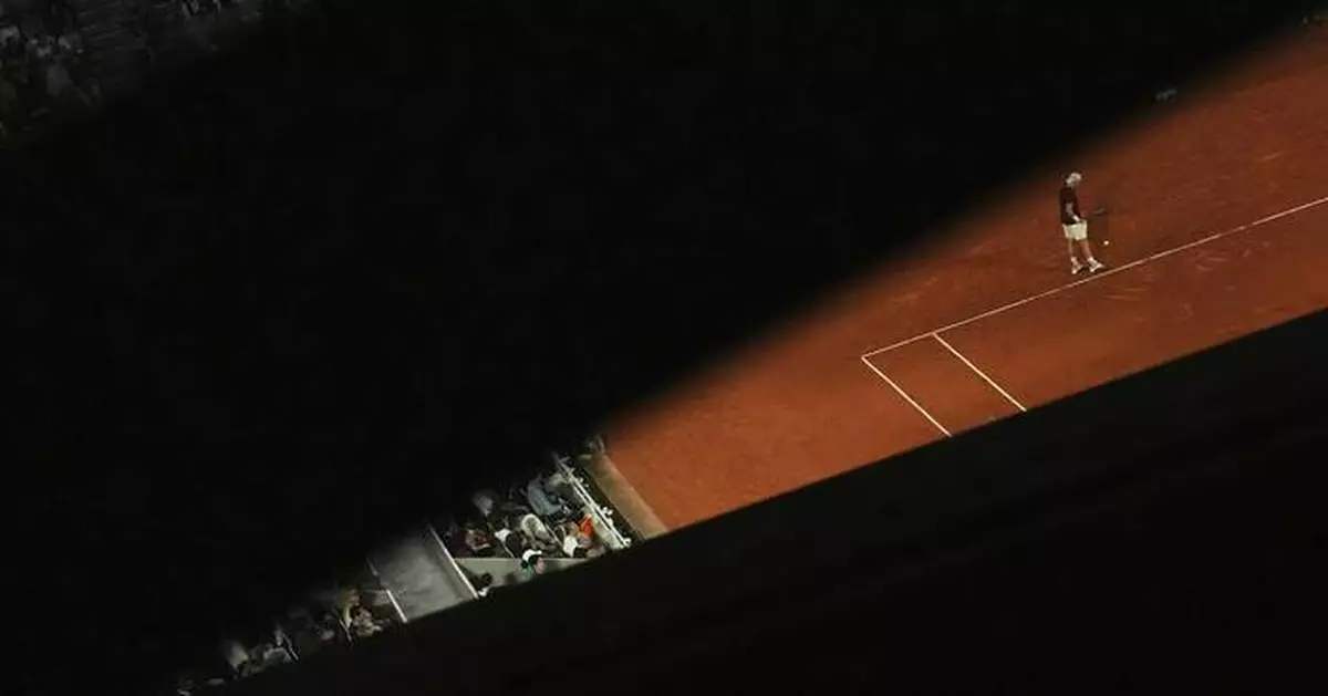 AP PHOTOS: Light and shadows add an extra dimension at the French Open tennis tournament