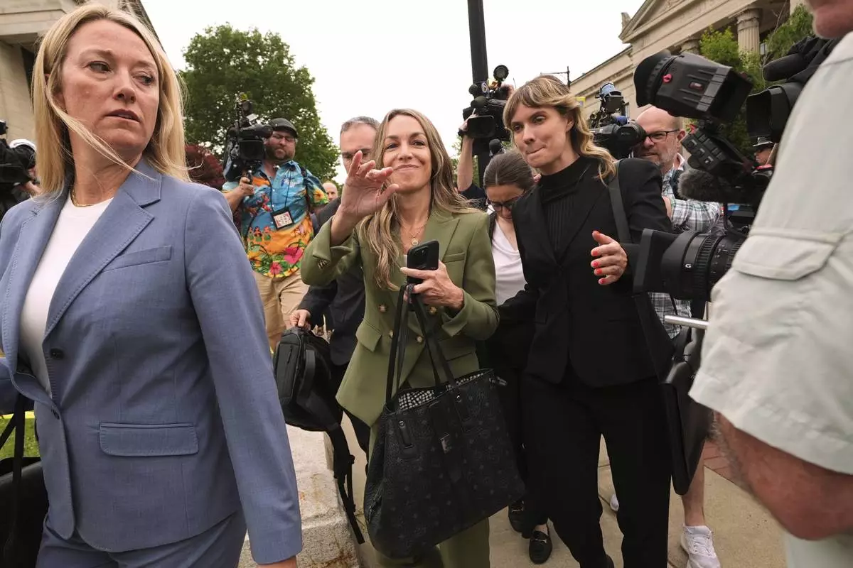 Karen Read gestures to her supporters while departing Norfolk Superior Court during jury deliberations at her trial, Tuesday, June 17, 2025, in Dedham, Mass. (AP Photo/Charles Krupa)