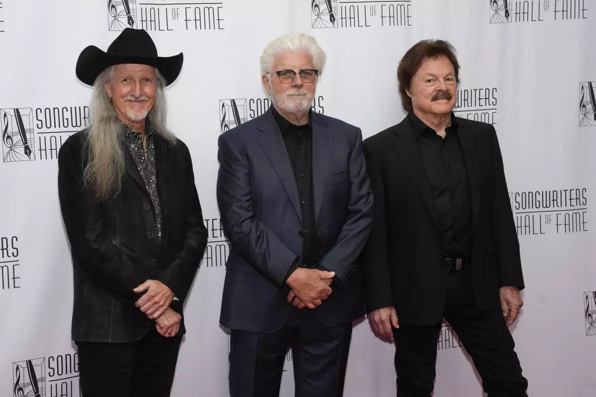 Patrick Simmons, Michael McDonald, Tom Johnston of the Doobie Brothers attend the 54th annual Songwriters Hall of Fame induction and awards gala on Thursday, June 12, 2025, at the Marriott Marquis Hotel in New York. (Photo by Charles Sykes/Invision/AP)