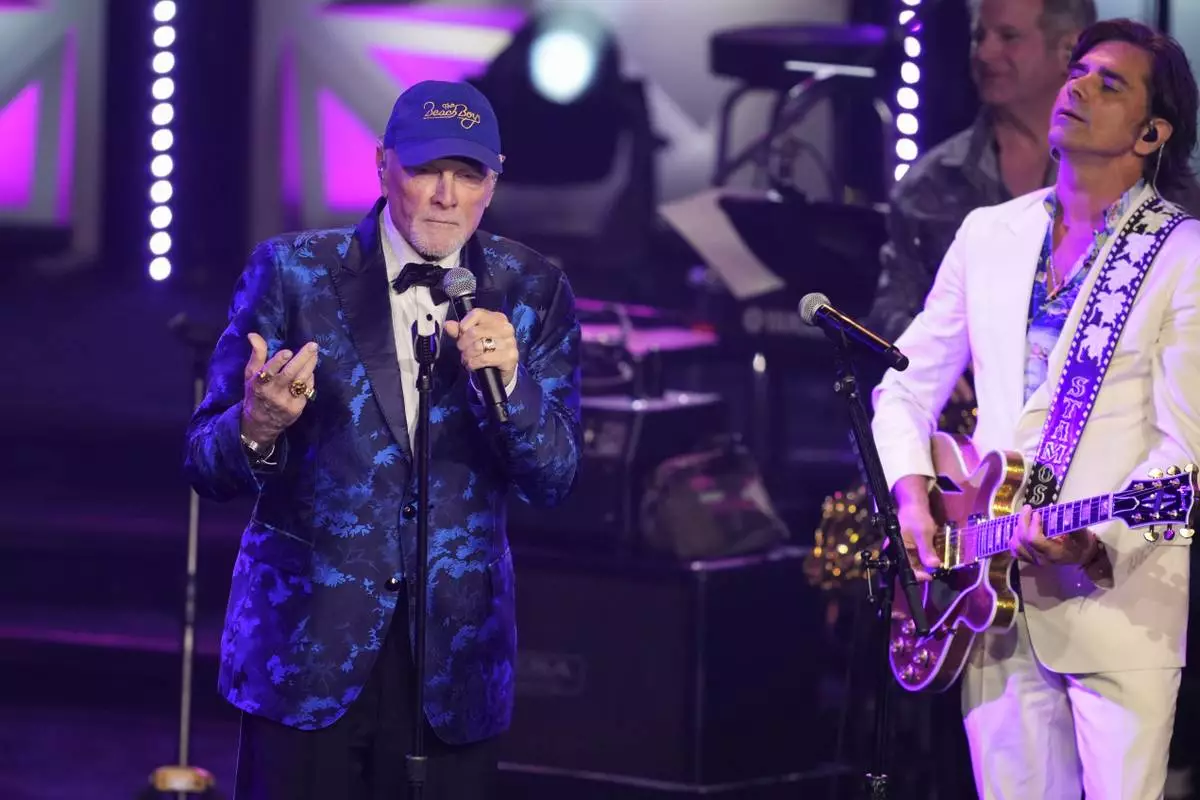 Mike Love, left, and John Stamos perform during the 54th annual Songwriters Hall of Fame induction and awards gala on Thursday, June 12, 2025, at the Marriott Marquis Hotel in New York. (Photo by Charles Sykes/Invision/AP)