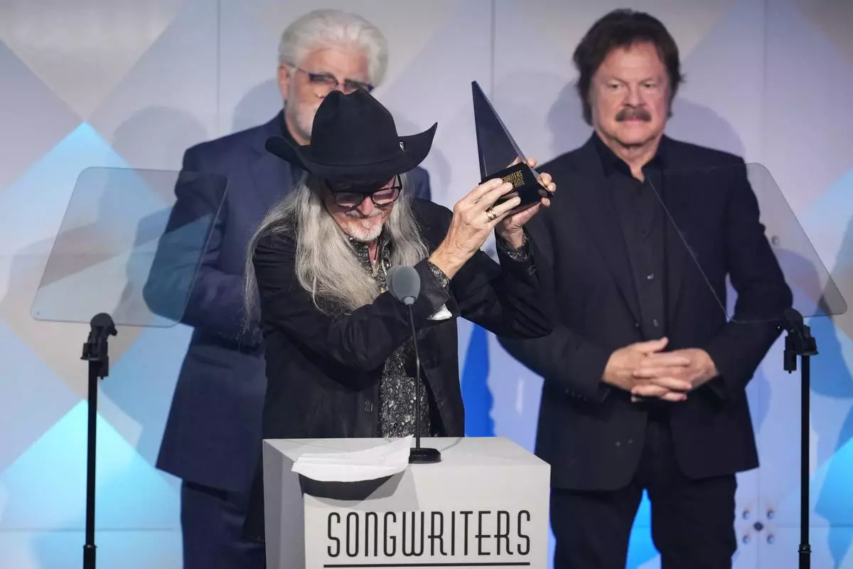 Michael McDonald, from left, Patrick Simmons, and Tom Johnston of The Doobie Brothers accept an award during the 54th annual Songwriters Hall of Fame induction and awards gala on Thursday, June 12, 2025, at the Marriott Marquis Hotel in New York. (Photo by Charles Sykes/Invision/AP)