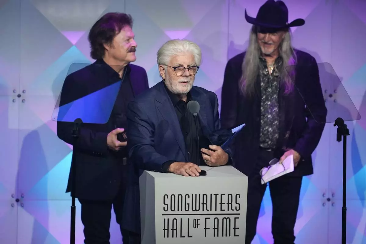 Tom Johnston, from left, Michael McDonald, and Patrick Simmons of The Doobie Brothers accept an award during the 54th annual Songwriters Hall of Fame induction and awards gala on Thursday, June 12, 2025, at the Marriott Marquis Hotel in New York. (Photo by Charles Sykes/Invision/AP)