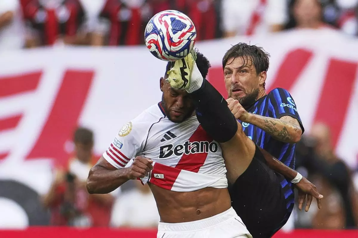 Inter Milan's Francesco Acerbi kicks at the ball as River Plate's Miguel Borja, left, reacts during the Club World Cup Group E soccer match between Inter Milan and River Plate in Seattle, Wednesday, June 25, 2025. (AP Photo/Ryan Sun)