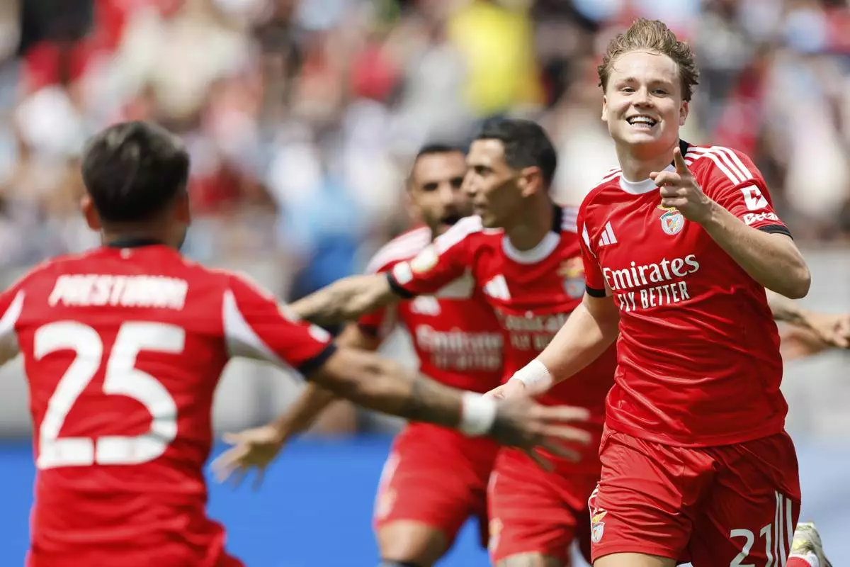 Benfica's Andreas Schjelderup and Gianluca Prestianni celebrate after scoring during the Club World Cup Group C soccer match between Benfica and Bayern Munich in Charlotte, N.C., Tuesday, June 24, 2025. (AP Photo/Nell Redmond)