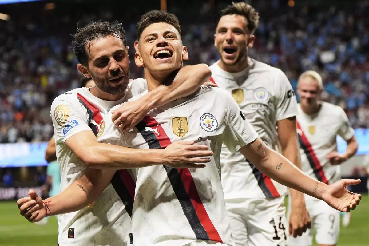 Manchester City's Claudio Echeverri is congratulated by teammates after scoring his team's second goal during the Club World Cup Group G soccer match between Manchester City and Al Ain in Atlanta, Sunday, June 22, 2025. (AP Photo/Mike Stewart)