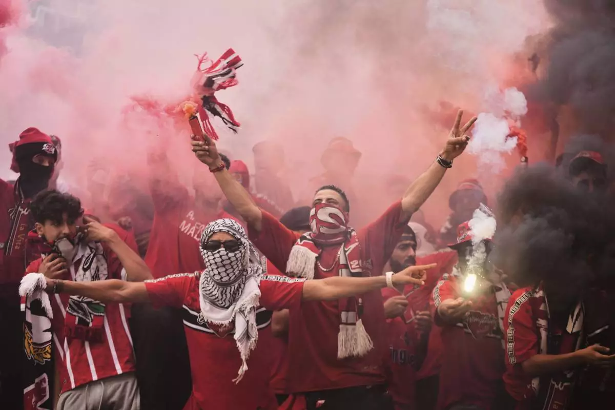 Wydad supporters light torches during the Club World Cup Group G soccer match between Juventus and Wydad AC in Philadelphia, Sunday, June 22, 2025. (AP Photo/Chris Szagola)