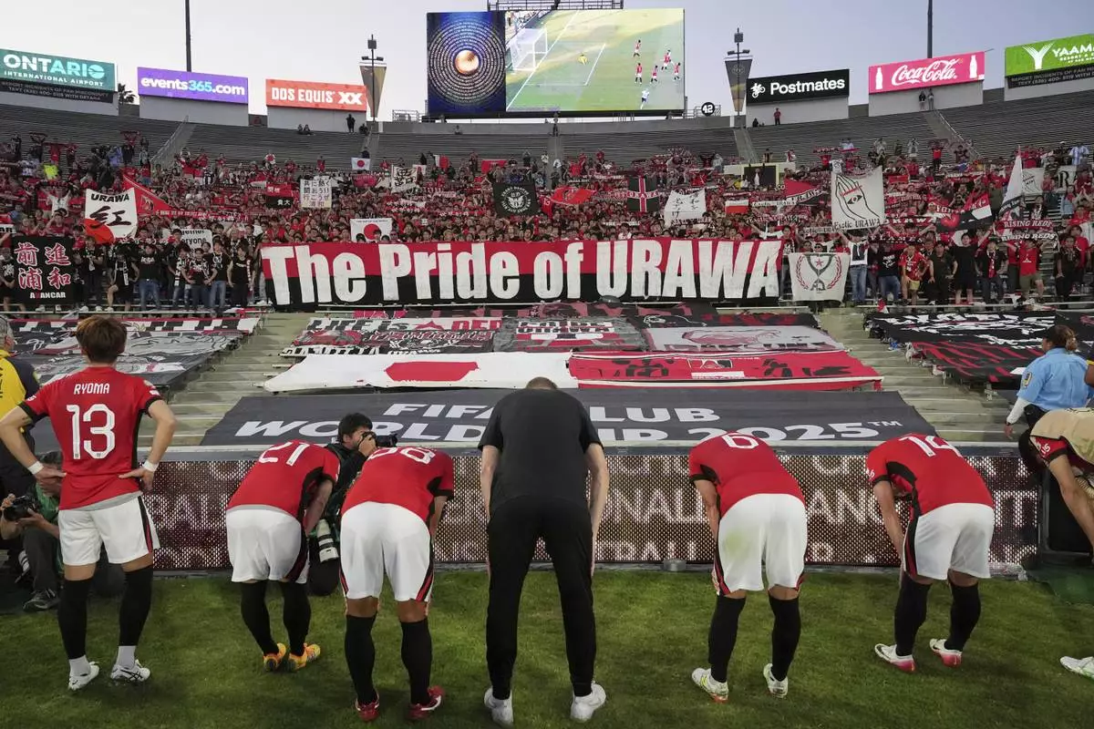 Urawa Red Diamonds players acknowledge fans following their loss in a Club World Cup Group E soccer match between Urawa Red Diamonds and CF Monterrey in Pasadena, Calif., Wednesday, June 25, 2025. (AP Photo/Gregory Bull)