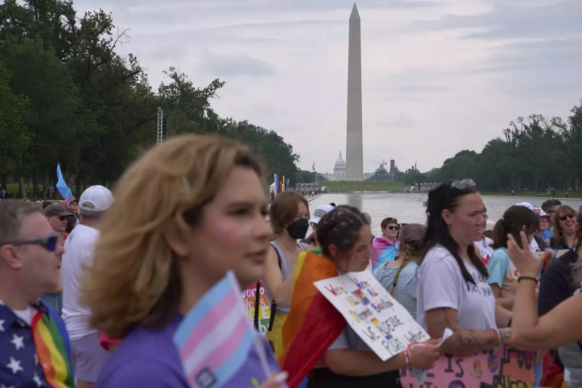 After marching with the National Trans Visibility March, Bella Bautista, 22, a trans woman, attends the World Pride Rally on the National Mall, Sunday, June 8, 2025, with the Washington Monument in the background in Washington. (AP Photo/Jacquelyn Martin)