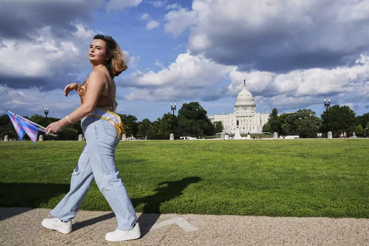 Bella Bautista, 22, a trans woman from Cartersville, Ga., walks past the U.S. Capitol after attending the World Pride Parade, Saturday, June 7, 2025, in Washington. (AP Photo/Jacquelyn Martin)