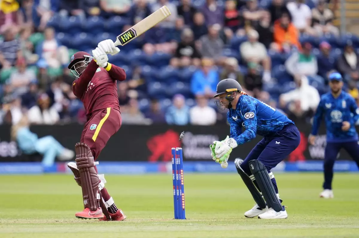 West Indies' Alzarri Joseph, left, is bowled by England's Adil Rashid during the second One Day International cricket match between West Indies and England at Sophia Gardens, Cardiff, Wales, Sunday, June 1, 2025. (Nick Potts/PA via AP)