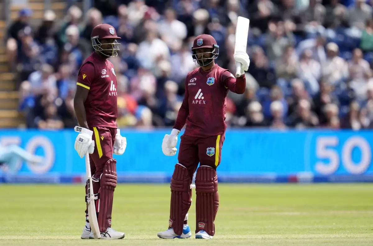West Indies' Shai Hope, right, celebrates reaching his fifty with Justin Greaves during the second One Day International cricket match between West Indies and England at Sophia Gardens, Cardiff, Wales, Sunday, June 1, 2025. (Nick Potts/PA via AP)
