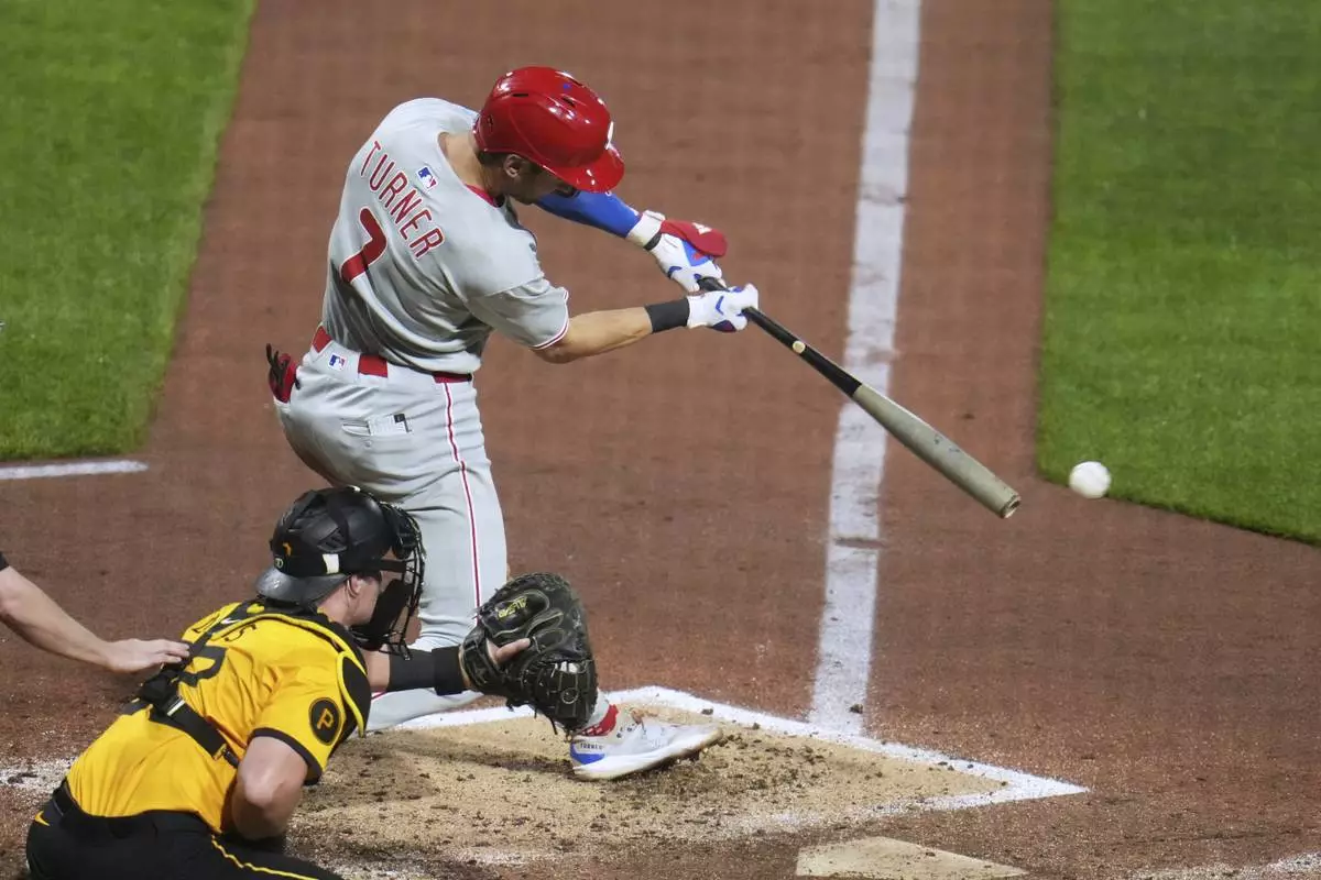 Philadelphia Phillies' Trea Turner (7) singles off Pittsburgh Pirates pitcher Chase Shugart, driving in two runs during the fourth inning of a baseball game in Pittsburgh, Friday, June 6, 2025. (AP Photo/Gene J. Puskar)