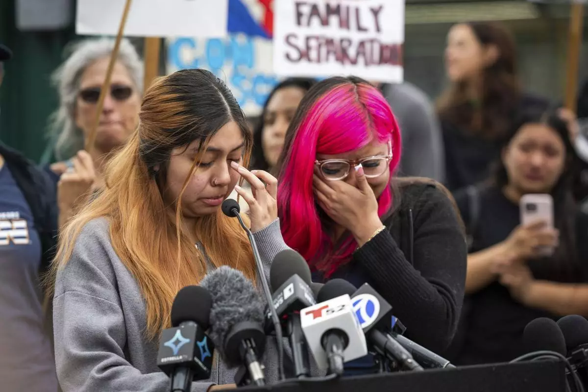 Kimberly Hernandez and her sister Jaslyn Hernandez, daughters of a car wash worker, speak during a press conference with families of detained car wash workers, Wednesday, June 11, 2025, in Culver City, Calif. (AP Photo/Ethan Swope)