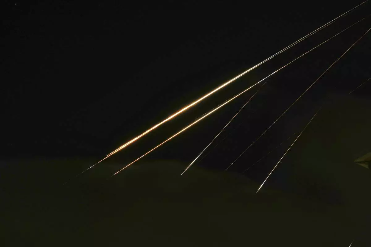 Traces of projectile illuminates the sky seen from northern Israel, Saturday, June 14, 2025. (AP Photo/Ariel Schalit)