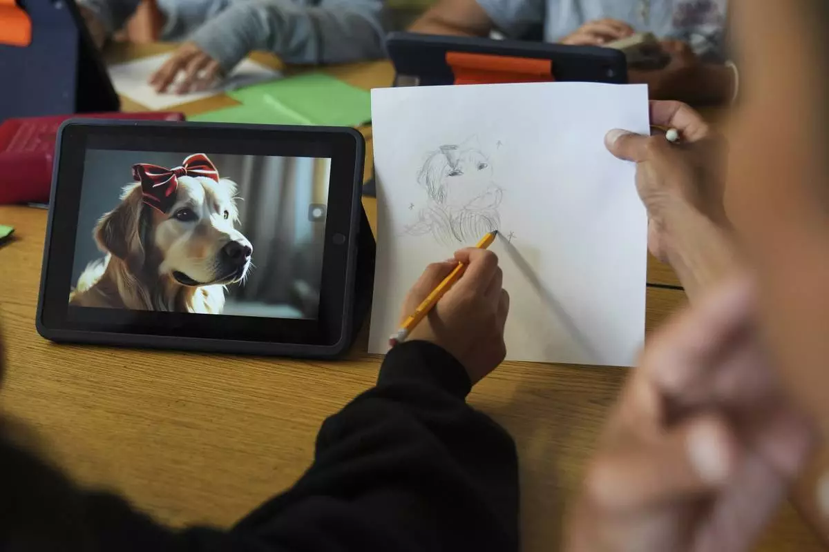CORRECT PROGRAM NAME: A student, left, talks with art teacher Lindsay Johnson about how to ask Canva for help during a summer class at Roosevelt Middle School, Wednesday, June 25, 2025, in River Forest, Ill. (AP Photo/Nam Y. Huh)