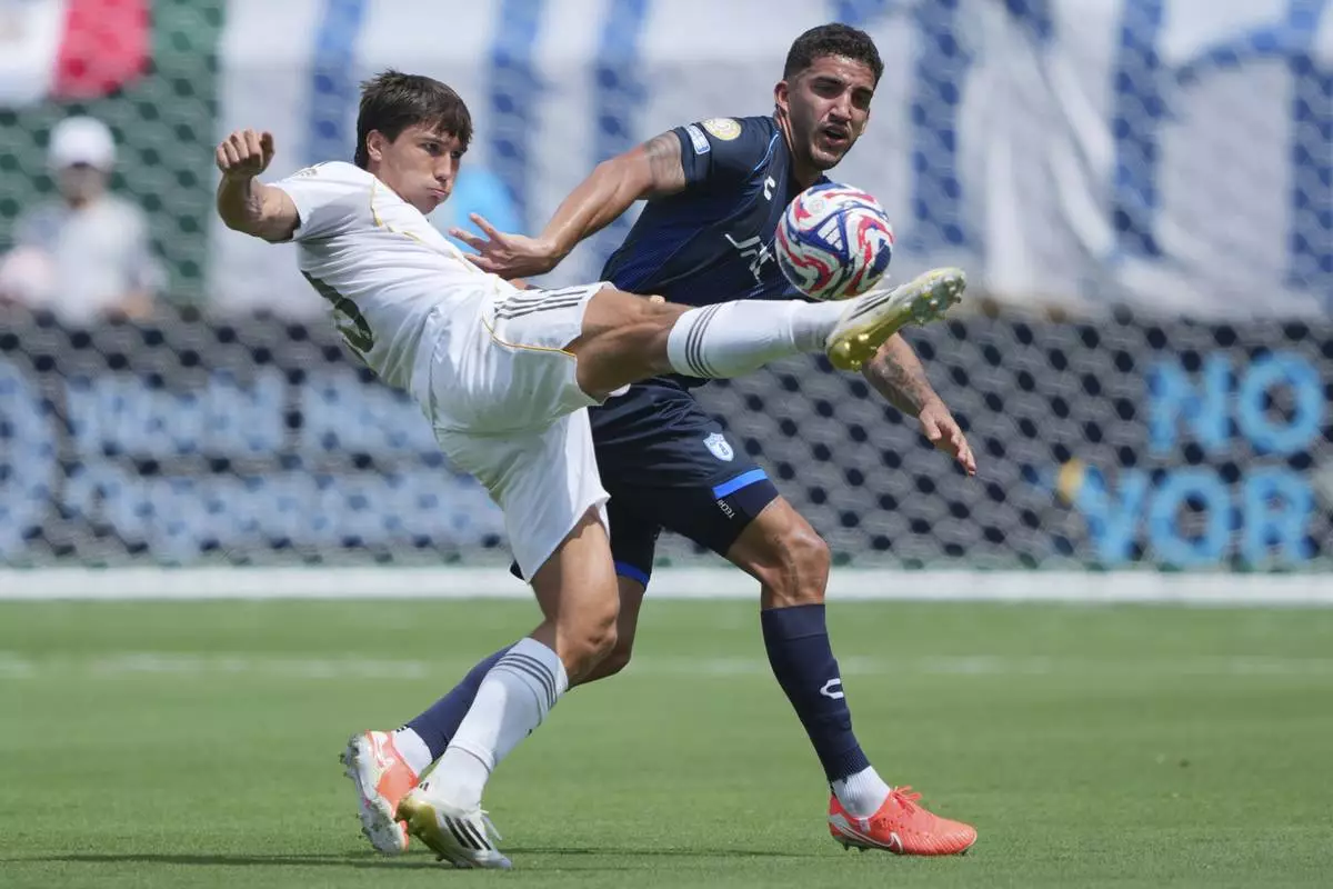 Real Madrid's Gonzalo Garcia, front, and Pachuca's Federico Pereira battle for the ball during the Club World Cup Group H soccer match between Real Madrid and CF Pachuca in Charlotte, N.C., Sunday, June 22, 2025. (AP Photo/Chris Carlson)