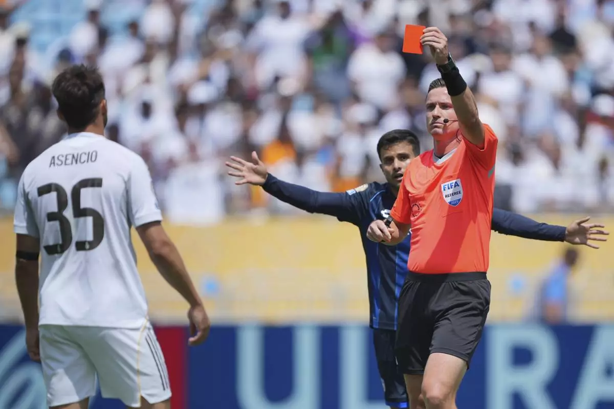 Referee Ramon Abatt shows a red card to Real Madrid's Raul Asencio during the Club World Cup Group H soccer match between Real Madrid and CF Pachuca in Charlotte, N.C., Sunday, June 22, 2025. (AP Photo/Chris Carlson)
