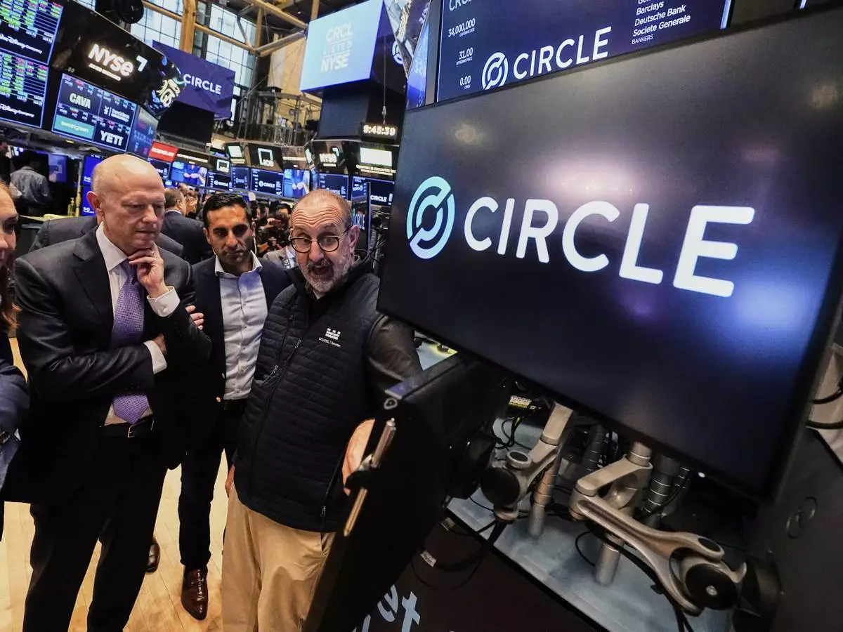 Jeremy Allaire, , left, Co-Founder, Chairman &amp; CEO of Circle, listens to specialist Peter Giacchi, right, before the IPO opens, on the floor of the New York Stock Exchange, Thursday, June 5, 2025. (AP Photo/Richard Drew)