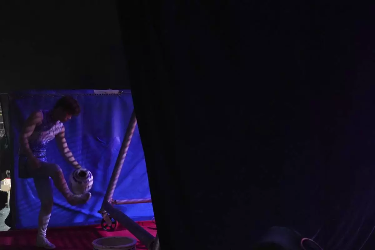 An acrobat from Dongchoon Circus Troupe warms up ahead of a daily regular performance in Ansan, South Korea, Tuesday, June 10, 2025. (AP Photo/Lee Jin-man)