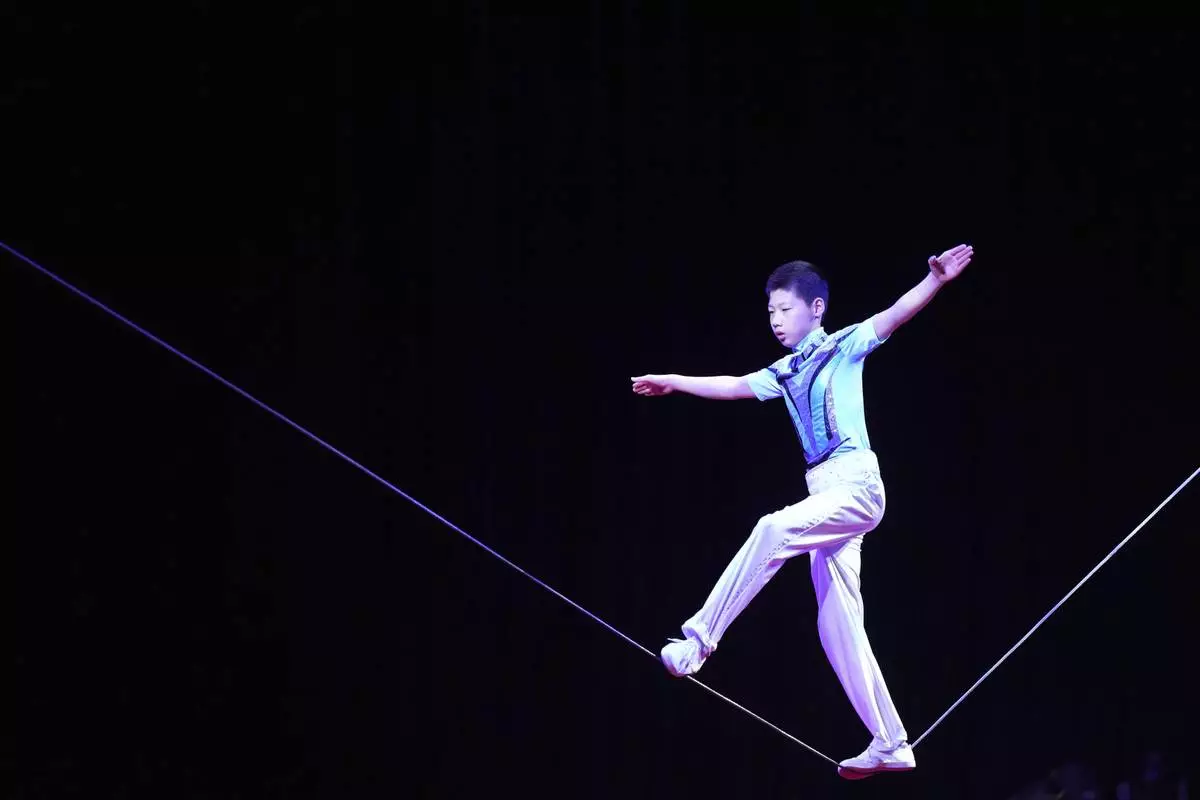 Acrobat Du Zhaofei, 15, performs during a daily regular performance in Ansan, South Korea, Tuesday, June 10, 2025. (AP Photo/Lee Jin-man)