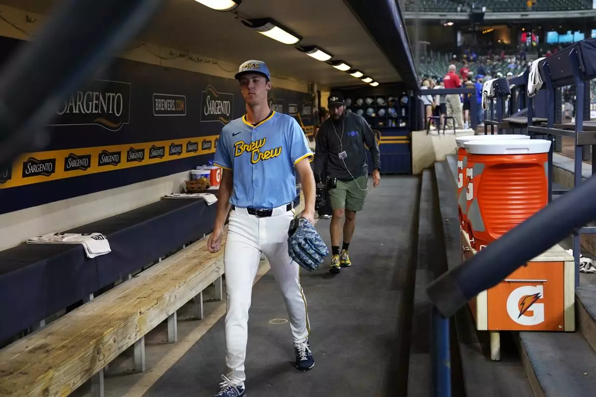 Milwaukee Brewers pitcher Jacob Misiorowski (33) walks through the dugout before warming up for his major league debut in a baseball game against the St. Louis Cardinals, Thursday, June 12, 2025, in Milwaukee. (AP Photo/Kayla Wolf)
