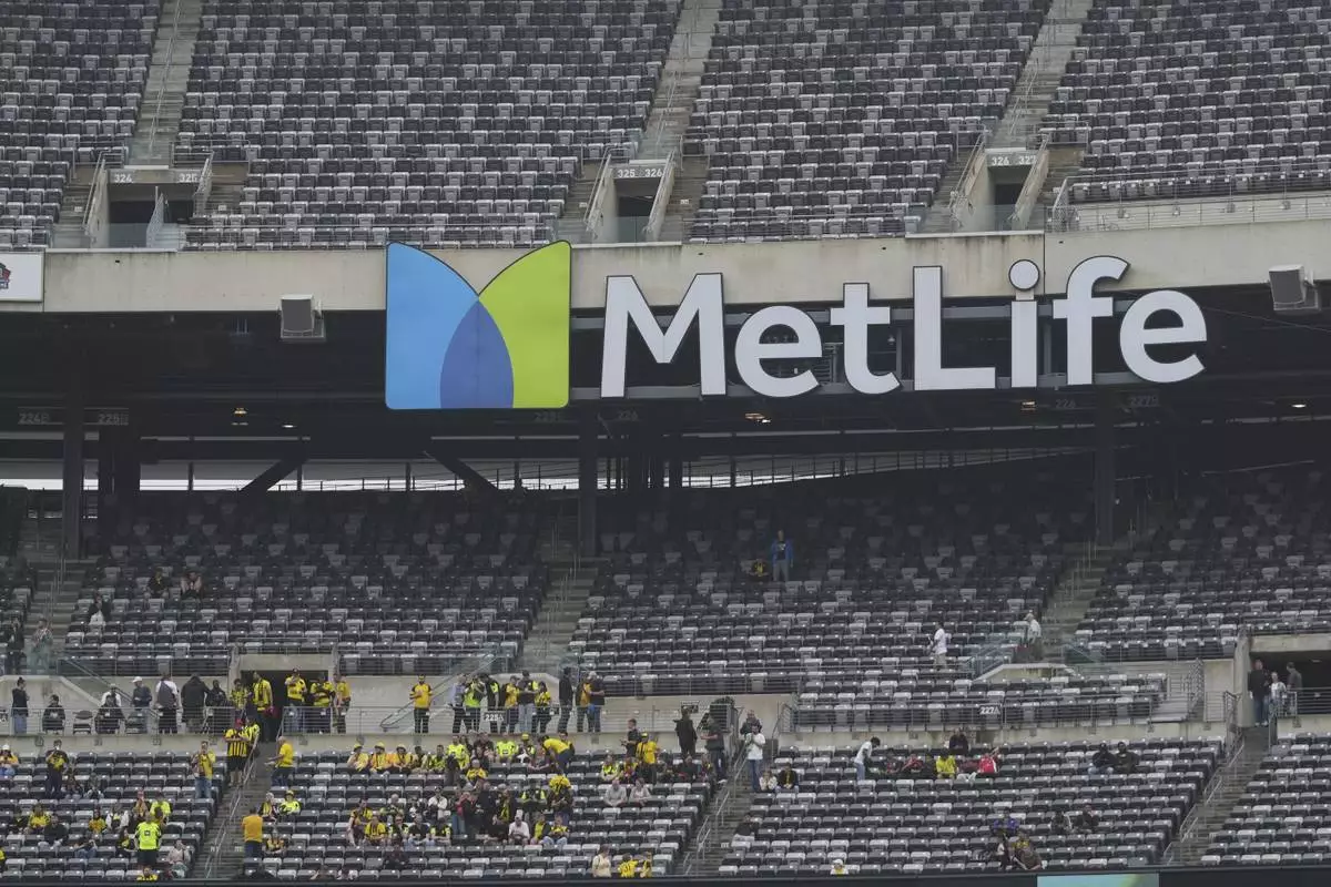 Fans take their seats for the Club World Cup group F soccer match between Fluminense and Borussia Dortmund in East Rutherford, N.J., Tuesday, June 17, 2025. (AP Photo/Seth Wenig)