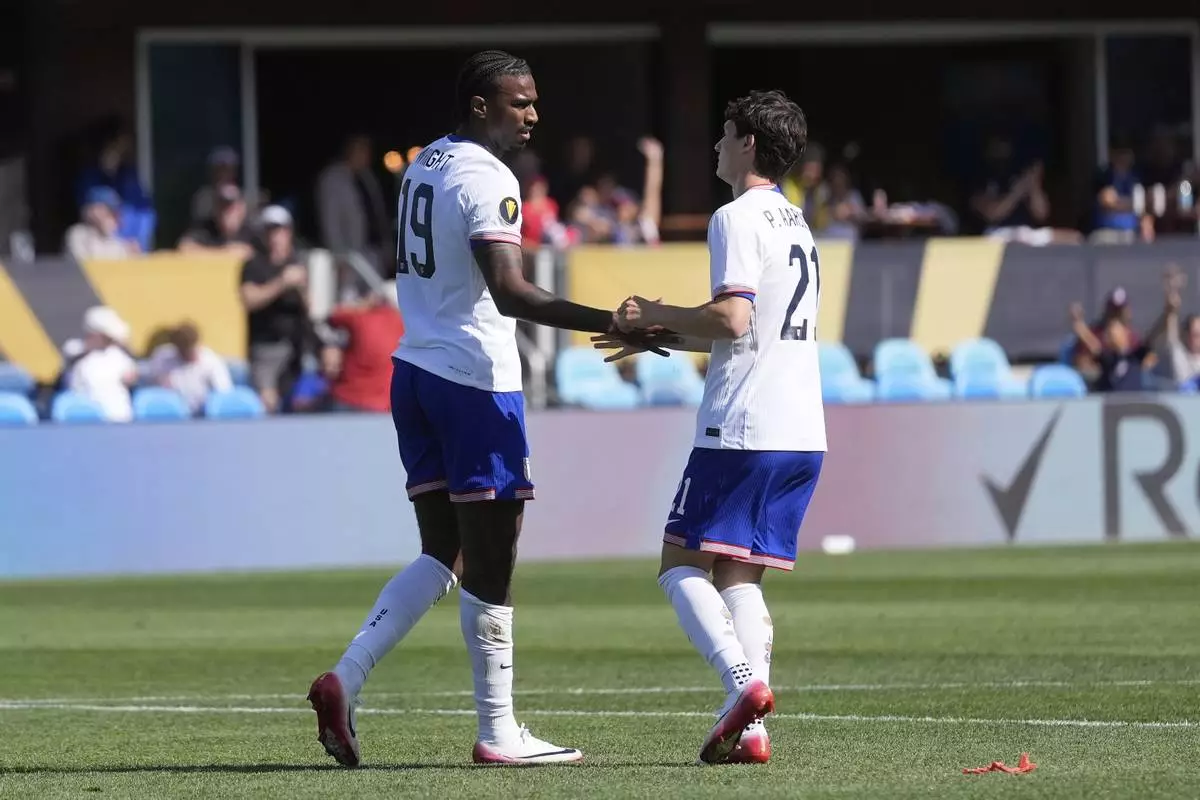 United States forward Haji Wright (19) is congratulated by midfielder Paxten Aaronson (21) after scoring against Trinidad and Tobago during the second half of a CONCACAF Gold Cup soccer match in San Jose, Calif., Sunday, June 15, 2025. (AP Photo/Jeff Chiu)