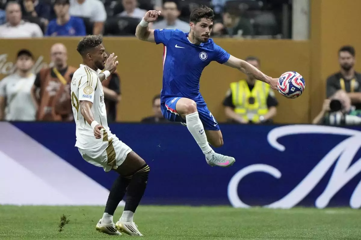 Chelsea's Pedro Neto, right, and Los Angeles FC's Denis Bouanga fight for the ball during the Club World Cup group D soccer match between Chelsea and Los Angeles FC in Atlanta, Monday, June 16, 2025. (AP Photo/Brynn Anderson)