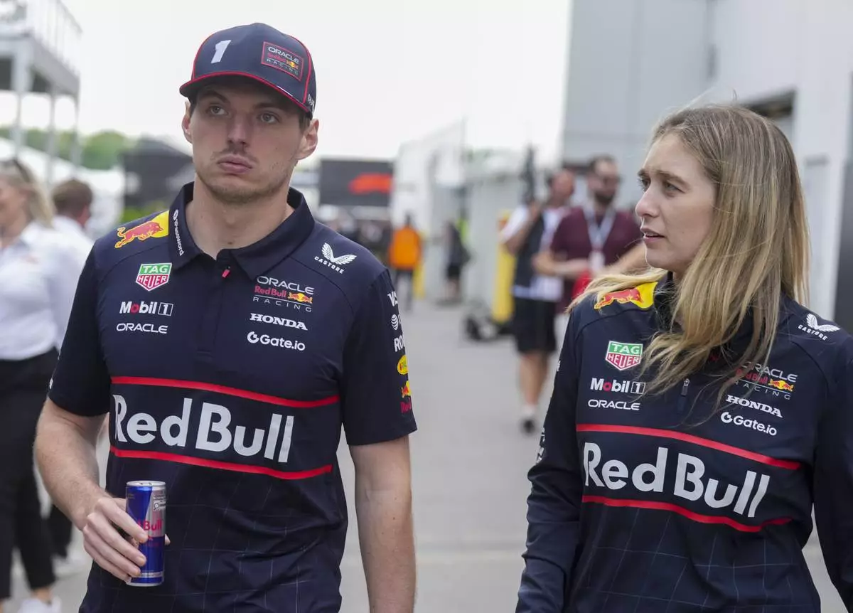 Red Bull Racing driver Max Verstappen, left, of the Netherlands, walks through the paddocks at the F1 Canadian Grand Prix auto race in Montreal, Thursday, June 12, 2025. (Christinne Muschi/The Canadian Press via AP)
