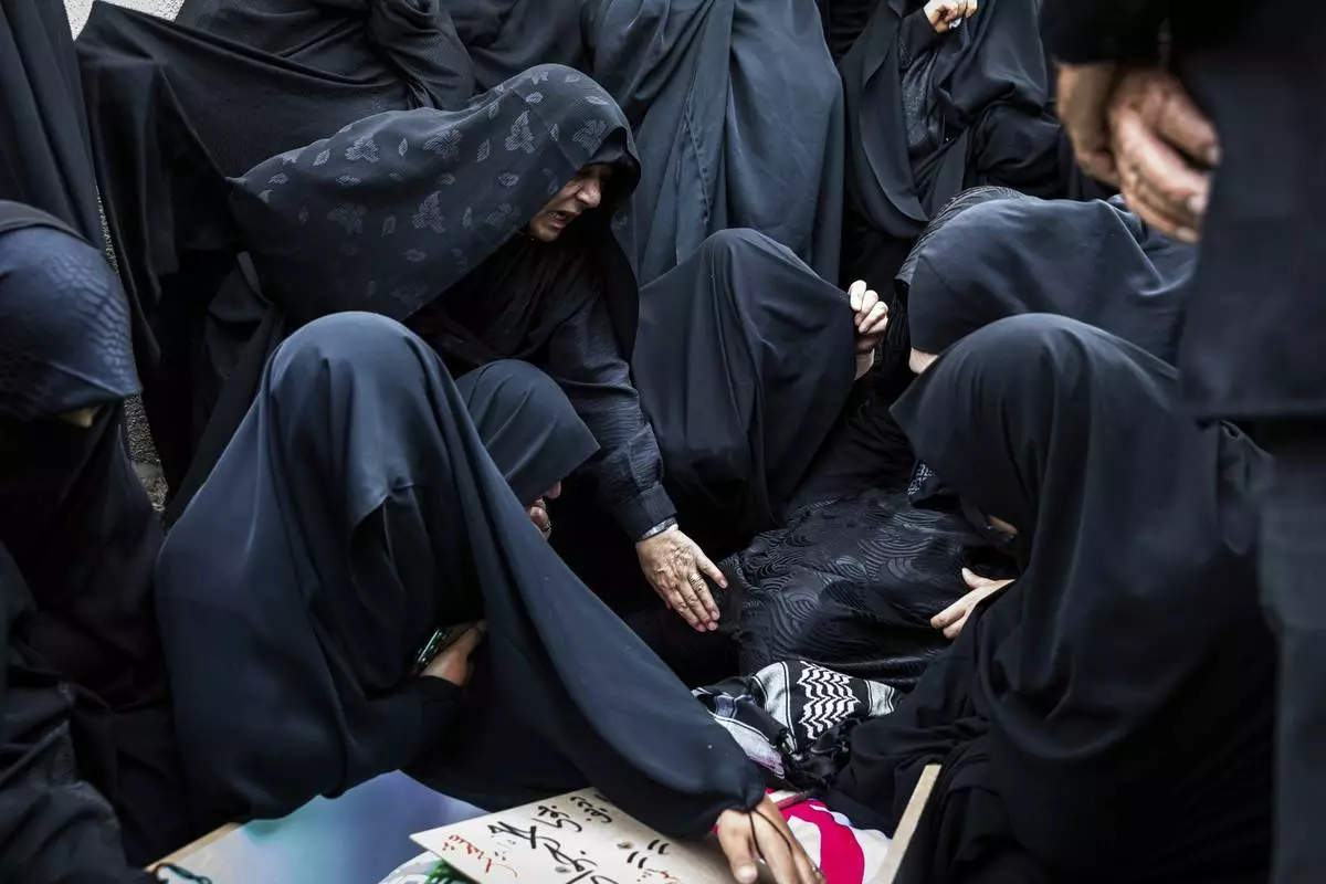 Women mourn over the body of Mohammadi Javad Naseri, who was reportedly killed in Israeli strikes in the northwestern Iranian city of Tabriz, Monday, June 16, 2025. (AP Photo/Matin Hashemi)
