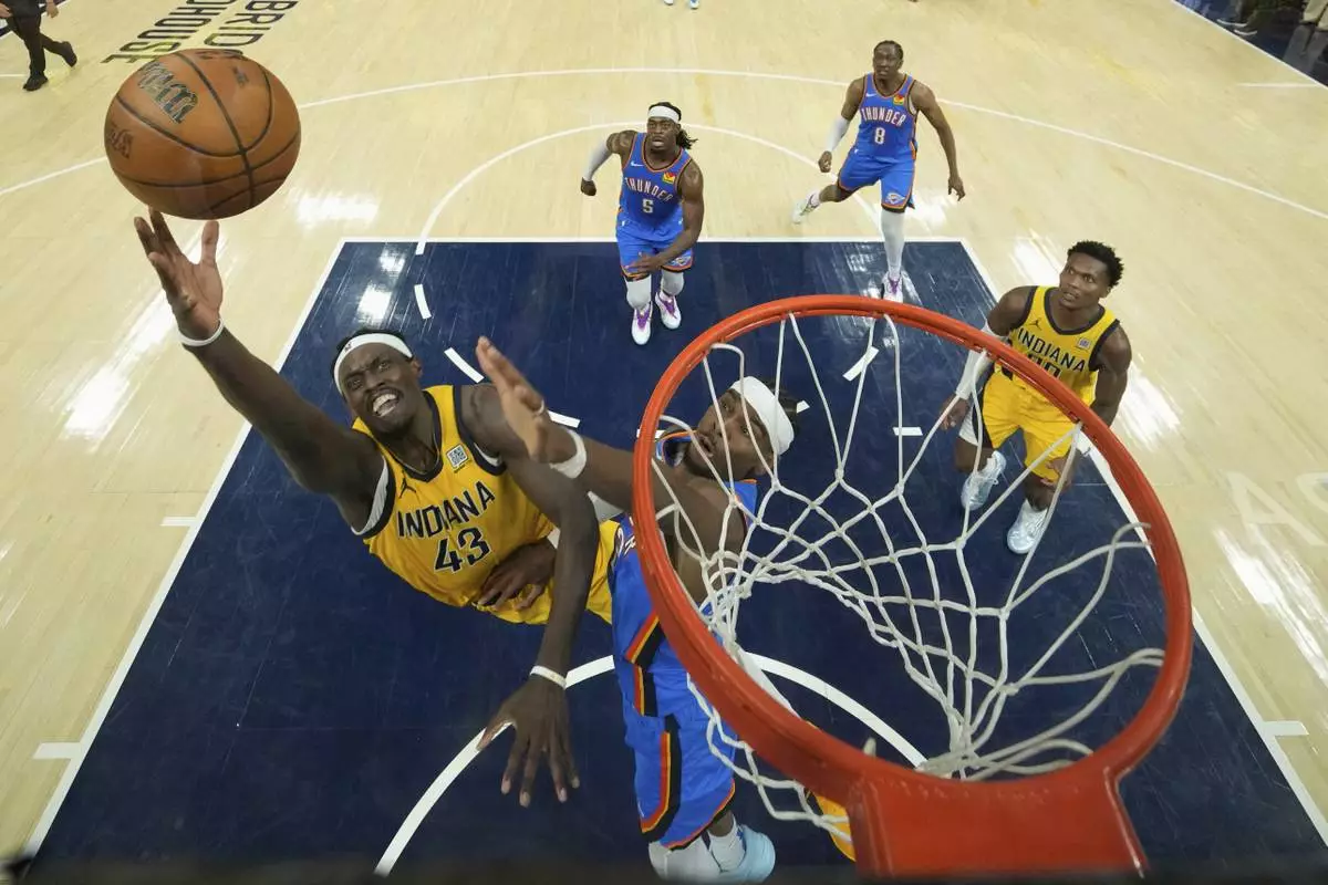 Indiana Pacers forward Pascal Siakam (43) shoots over Oklahoma City Thunder guard Luguentz Dort during the first half of Game 3 of the NBA Finals basketball series, Wednesday, June 11, 2025, in Indianapolis. (AP Photo/Abbie Parr)