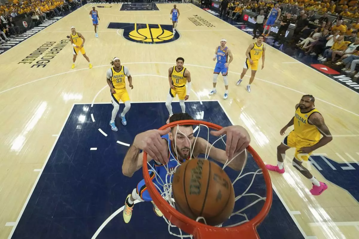 Oklahoma City Thunder forward Chet Holmgren (7) dunks against the Indiana Pacers during the first half of Game 3 of the NBA Finals basketball series, Wednesday, June 11, 2025, in Indianapolis. (AP Photo/Abbie Parr)