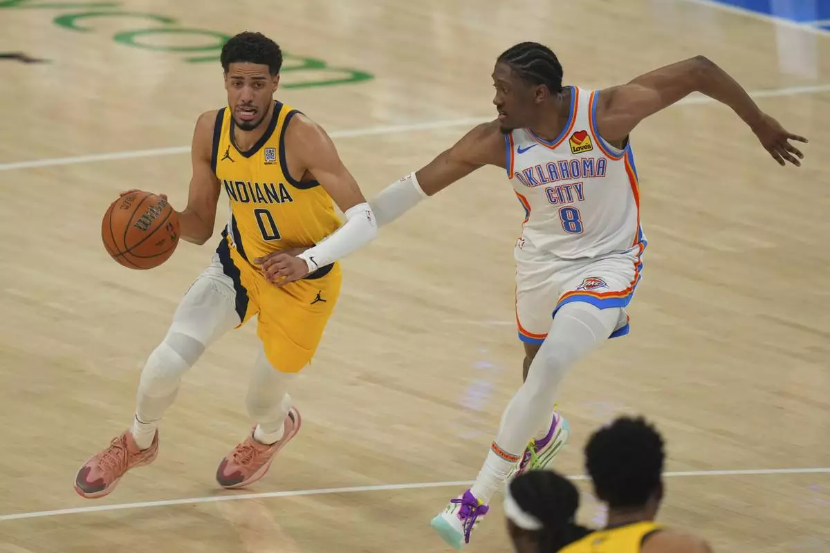 Indiana Pacers guard Tyrese Haliburton (0) drives as Oklahoma City Thunder forward Jalen Williams (8) defends during the first half of Game 5 of the NBA Finals basketball series, Monday, June 16, 2025, in Oklahoma City. (AP Photo/Nate Billings)