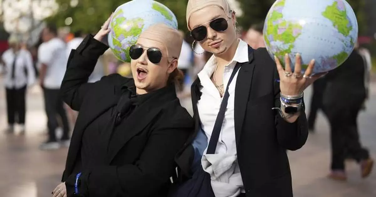 White shirts. Black ties. Bald caps. Pitbull’s fans party like clones worldwide