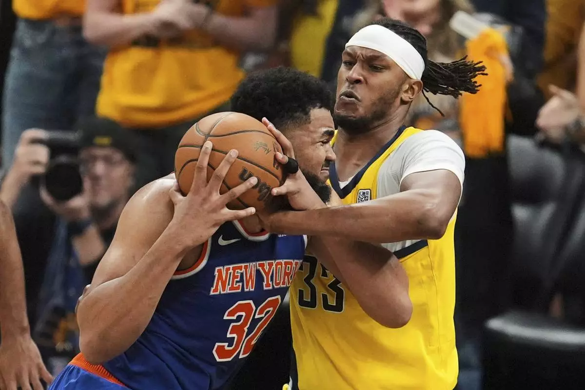 Indiana Pacers center Myles Turner (33) defends against New York Knicks center Karl-Anthony Towns (32) during the second half of Game 6 of the Eastern Conference finals of the NBA basketball playoffs in Indianapolis, Saturday, May 31, 2025. (AP Photo/Michael Conroy)