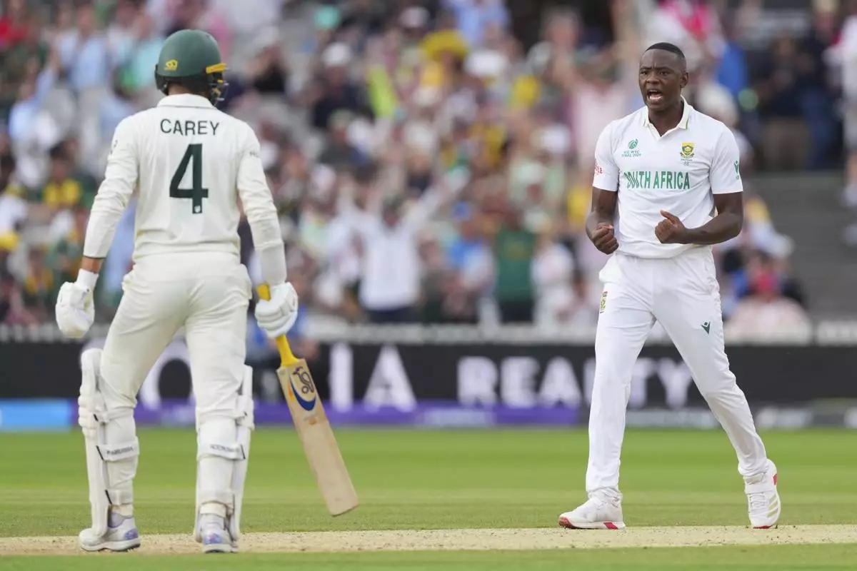 South Africa's Kagiso Rabada, right, celebrates the dismissal of Australia's Alex Carey, left, on day two of the World Test Championship final between South Africa and Australia at Lord's cricket ground in London, Thursday, June 12, 2025. (AP Photo/Kirsty Wigglesworth)